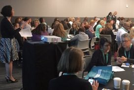 Participants at the Tell Me More® workshop at the Cleveland Clinic's Patient Experience Seminar examine the MyMoments mobile app on May 23 with guidance from Elizabeth Cleek, Chief Program Officer at the Gold Foundation.