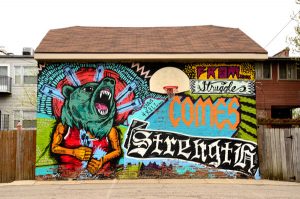 This mural was painted by artist Sentrock on a garage in North Lawndale. Titled "From Struggle Comes Strength," it embodies the spirit of the neighborhood. (Credit: Tiffany Huang)
