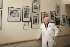 Dr. Joseph Gascho with portraits of patients